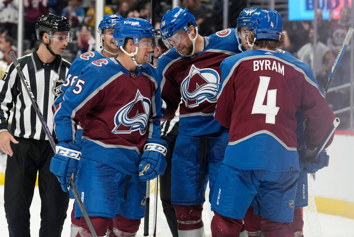 Colorado Avalanche defenseman Kurtis MacDermaid, second from left, is congratulated after scori ...