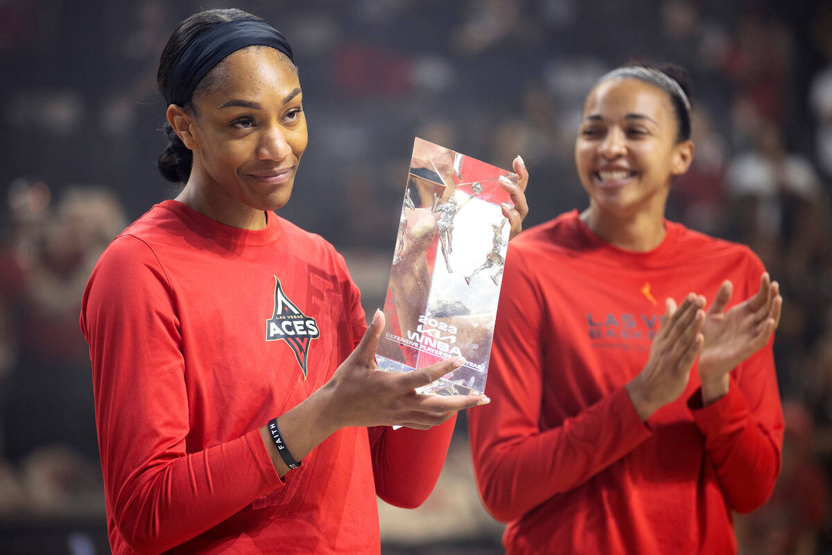 Las Vegas Aces forward A'ja Wilson accepts her award for WNBA Defensive Player of the Year alon ...
