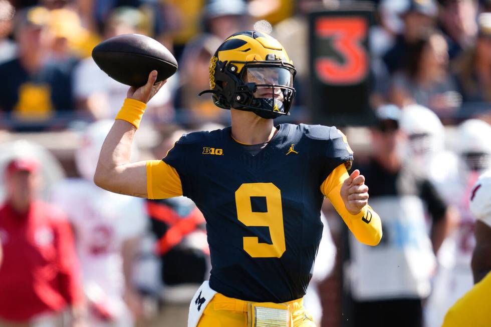 Michigan quarterback J.J. McCarthy (9) throws against Rutgers in the first half of an NCAA coll ...