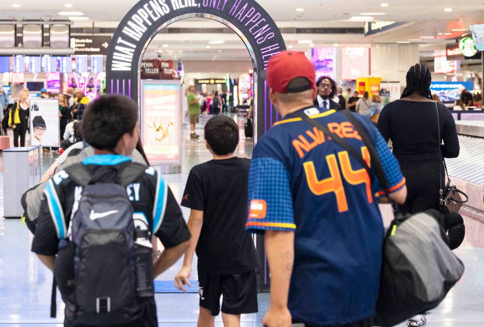 Arriving passengers head to baggage claim area at Terminal 1 of Harry Reid International Airpor ...