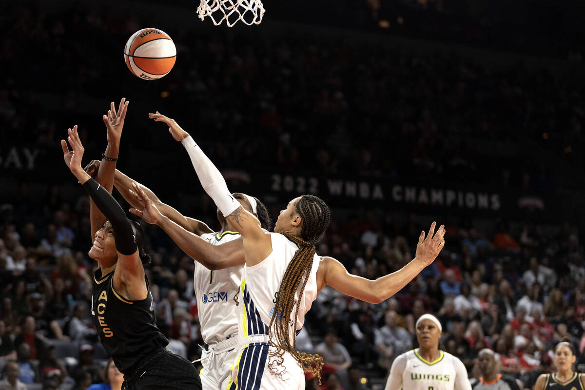 Las Vegas Aces forward A'ja Wilson (22) falls down while shooting against Dallas Wings center T ...