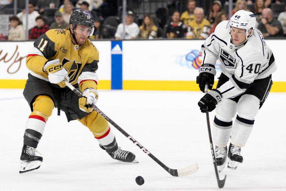 Golden Knights forward Mason Morelli (11) skates for the puck against Kings defenseman Joe Hick ...