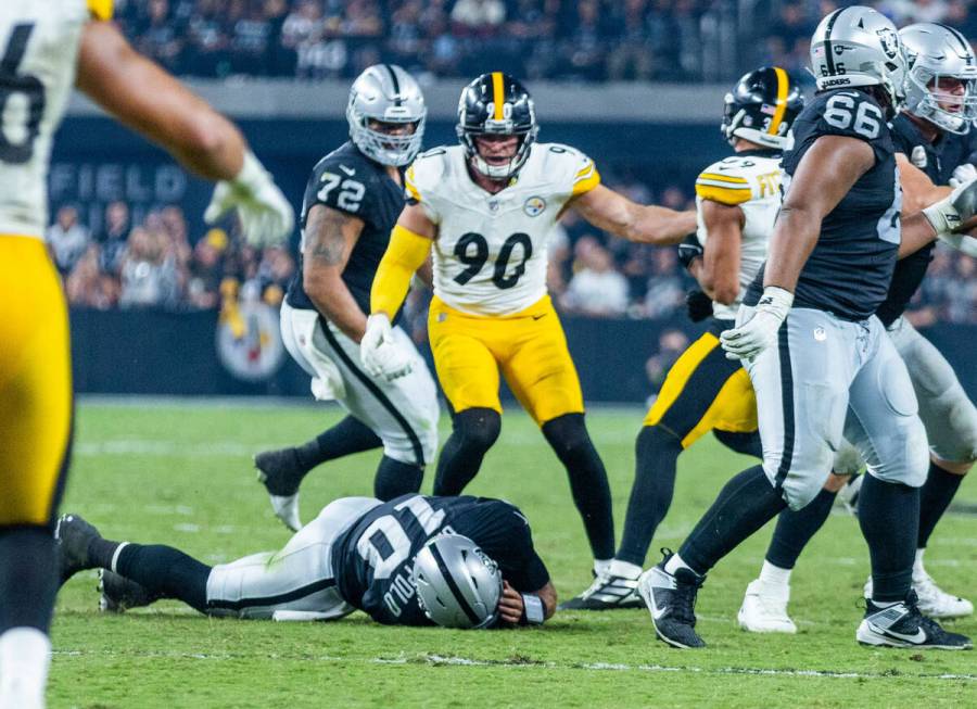 Raiders quarterback Jimmy Garoppolo (10) is down on the turf again in pain after another sack b ...