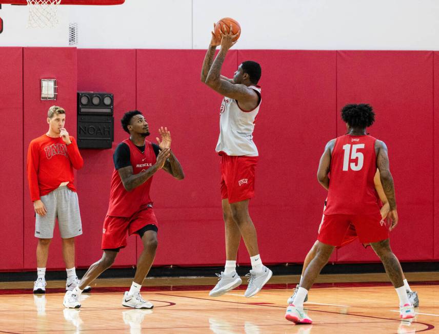 UNLV Rebels forward Karl Jones (22) shoots for the basket as guards Kalib Boone (10) and Luis R ...