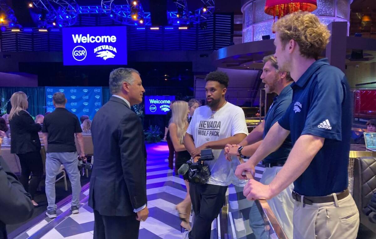 University of Nevada president Brian Sandoval, center left, talks to Wolf Pack fans at the Gran ...