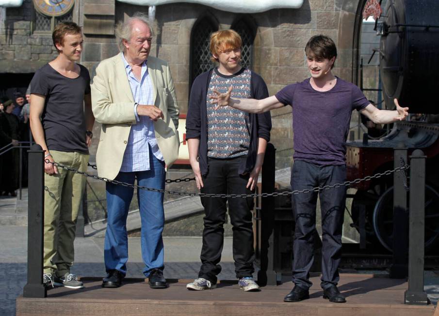 FILE - Members of the cast of the Harry Potter films, from left, Tom Felton, Michael Gambon, Ru ...