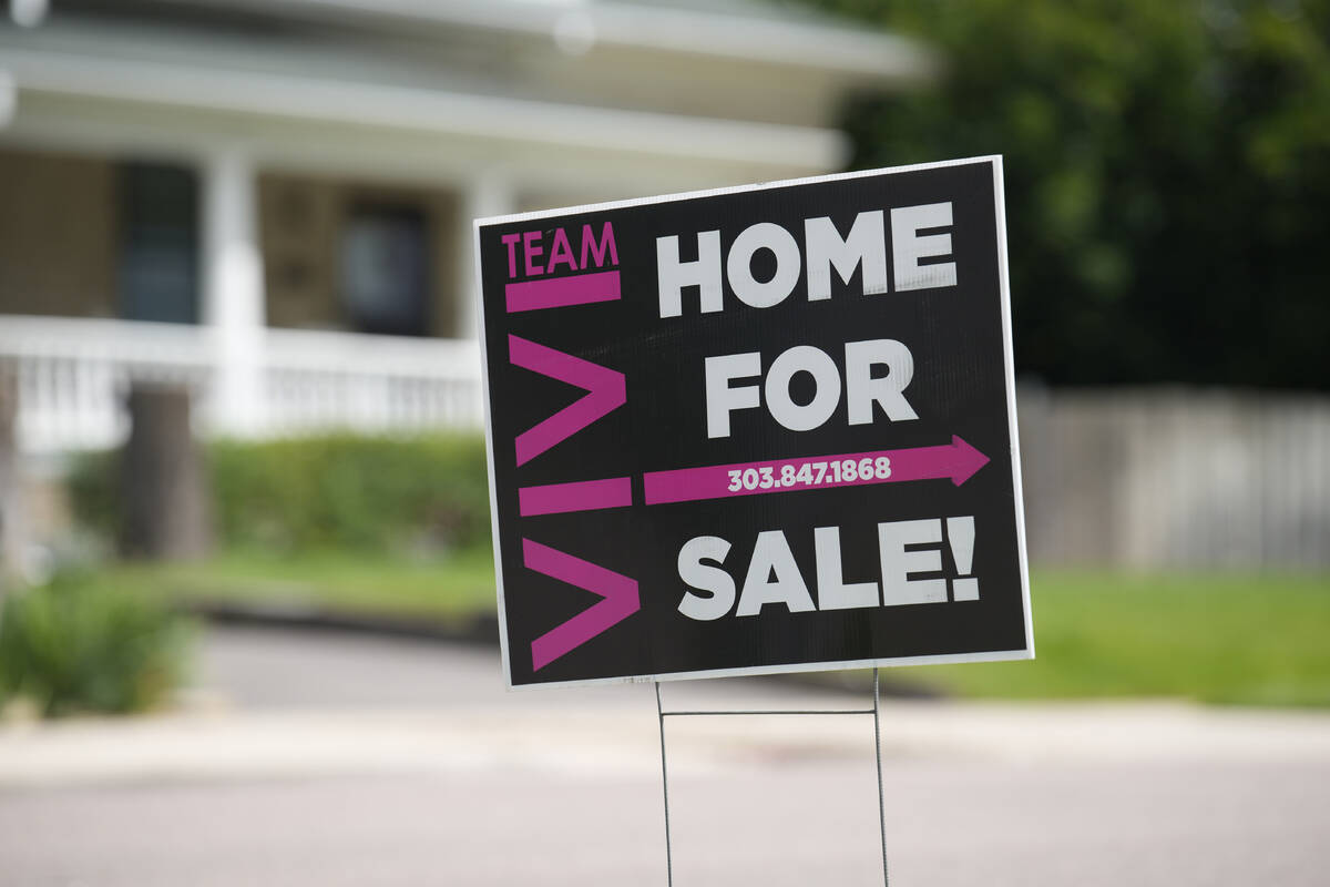 A for sale sign stands outside a single-family residence on Sunday, June 18, 2023, in Denver. O ...