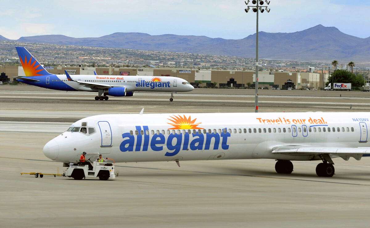 FILE- In this May 9, 2013, file photo, two Allegiant Air jets taxi at McCarran International Ai ...