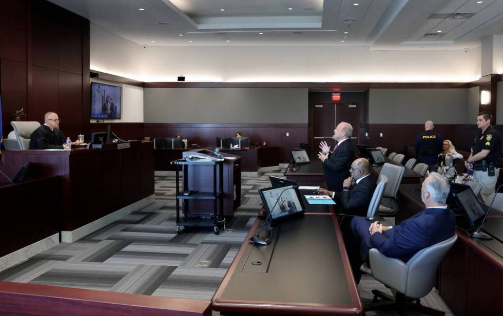 Clark County Chief Deputy District Attorney Marc DiGiacomo, standing center, addresses Chief Ju ...