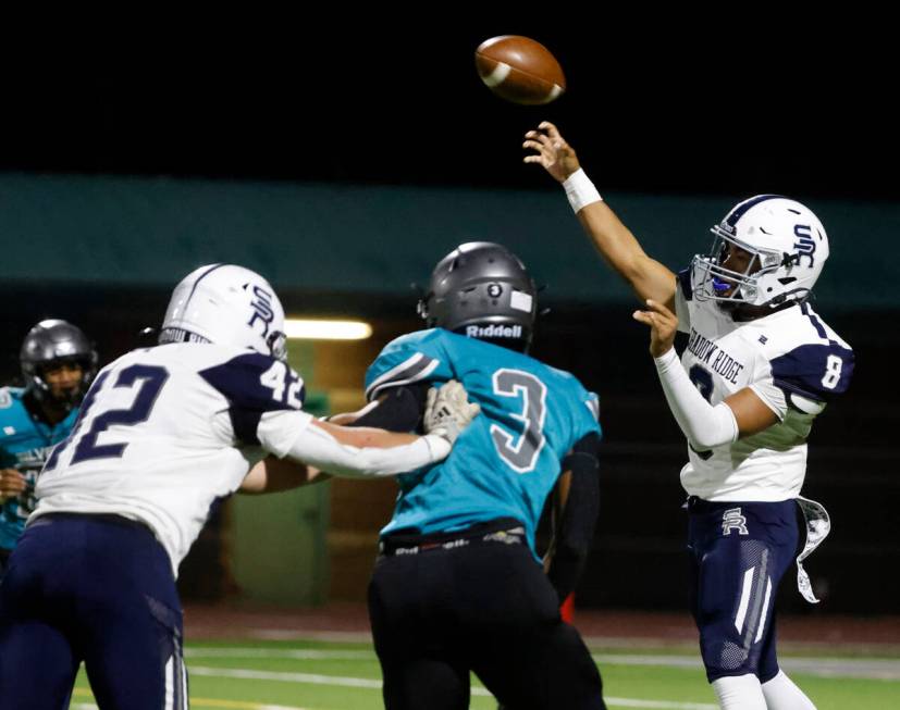 Shadow Ridge quarterback Coen Coloma (8) throws a pass as Silverado High Marcus Council (3) put ...