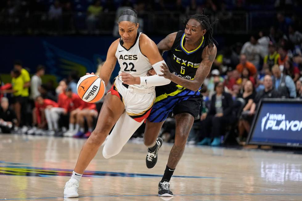 Las Vegas Aces forward A'ja Wilson (22) drives against Dallas Wings forward Natasha Howard (6) ...