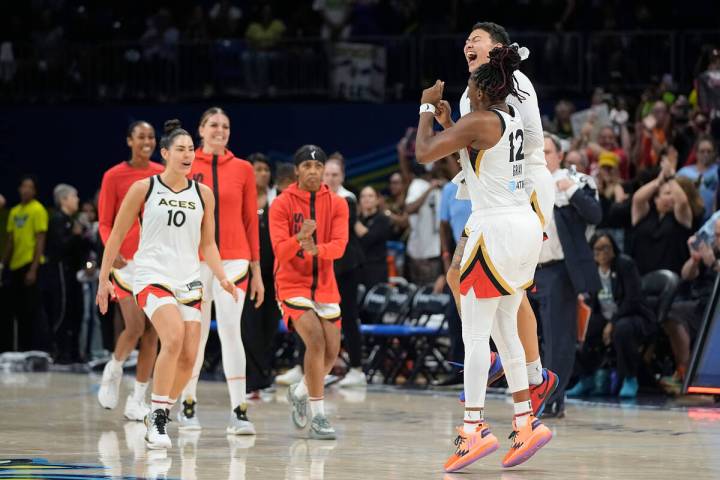 Las Vegas Aces guard Chelsea Gray (12) celebrates with guard Kierstan Bell, behind, after the t ...