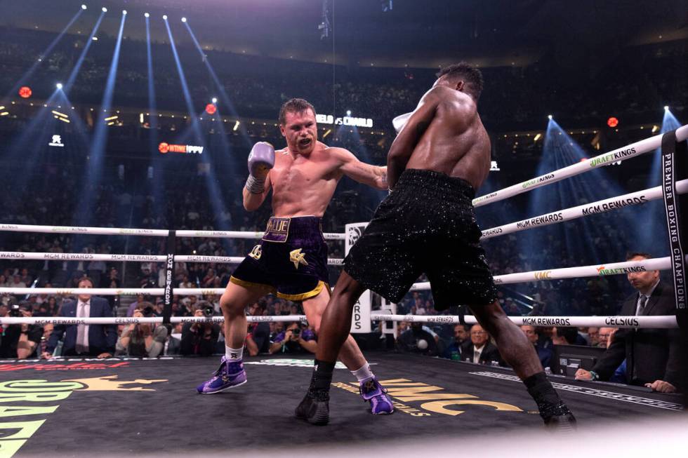 Canelo Alvarez hits Jermell Charlo during an undisputed world super middleweight title boxing b ...