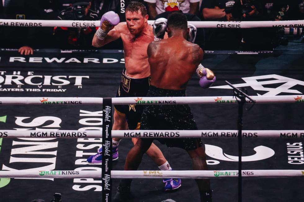 Canelo Alvarez punches Jermell Charlo during an undisputed world super middleweight title boxin ...