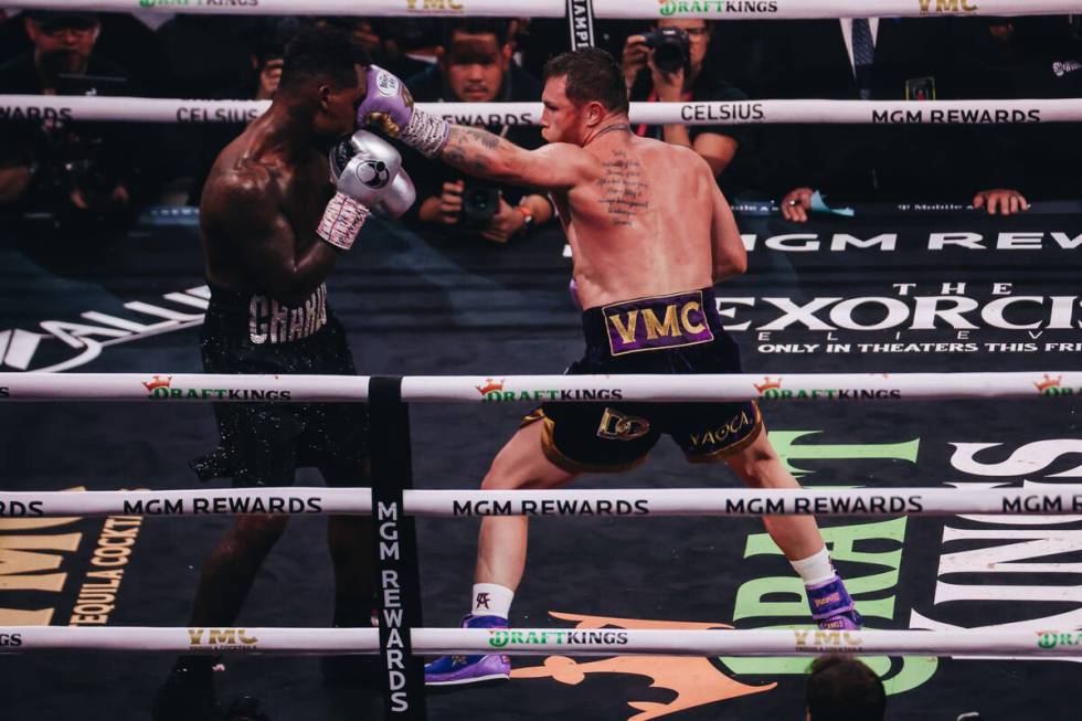 Canelo Alvarez punches Jermell Charlo during an undisputed world super middleweight title boxin ...