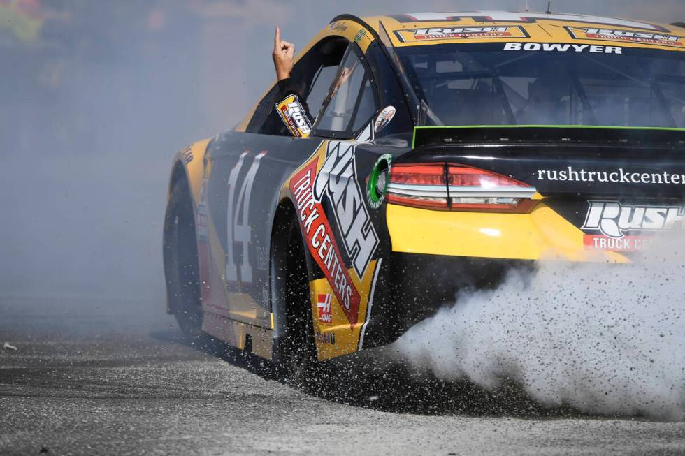 Clint Bowyer (14) points to the sky while doing donuts during the 2018 NASCAR Burnout Blvd even ...