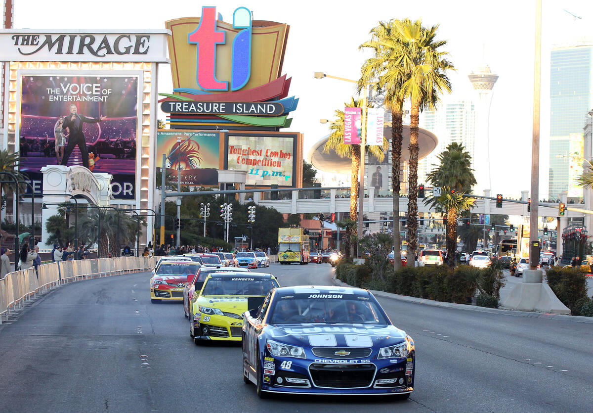 Jimmie Johnson leads a victory lap on the Las Vegas Strip during NASCAR Champions Week on Thurs ...