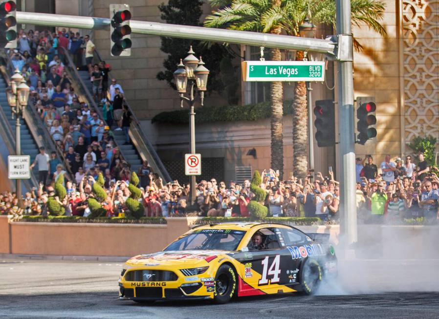 Clint Bowyer does a burnout at the intersection of East Sands Avenue and South Las Vegas Boulev ...