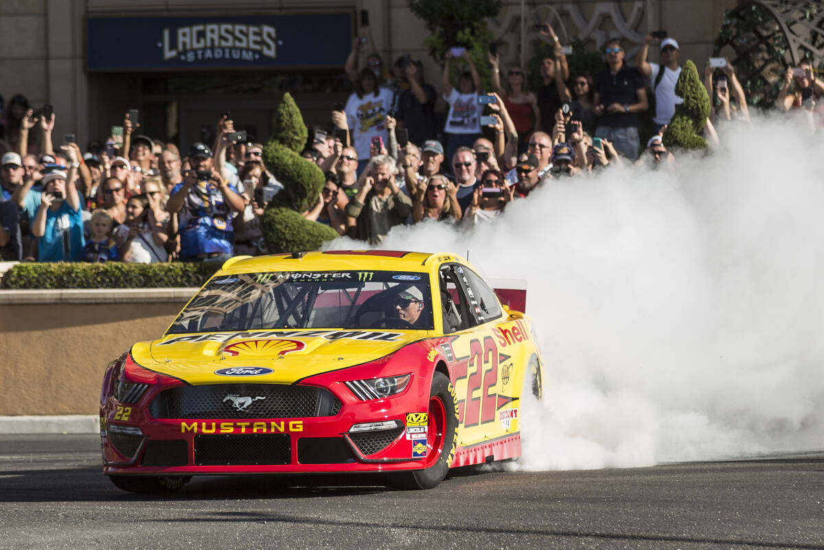 Joey Logano does a burnout at the intersection of East Sands Avenue and South Las Vegas Bouleva ...