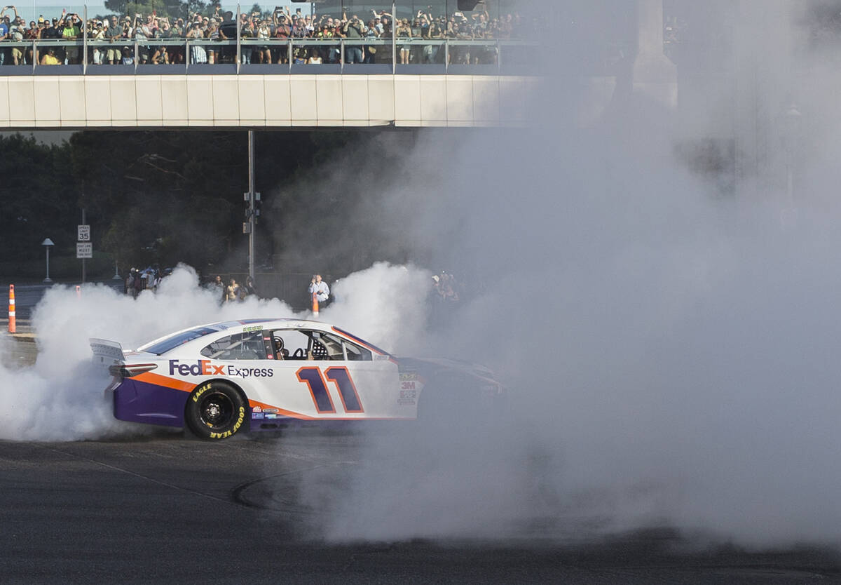 Denny Hamlin does a burnout at the intersection of East Sands Avenue and South Las Vegas Boulev ...
