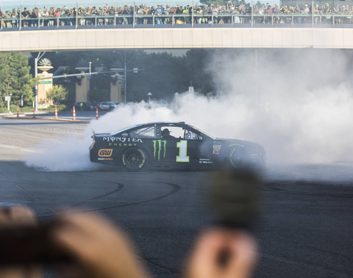 Kurt Busch does a burnout at the intersection of East Sands Avenue and South Las Vegas Boulevar ...