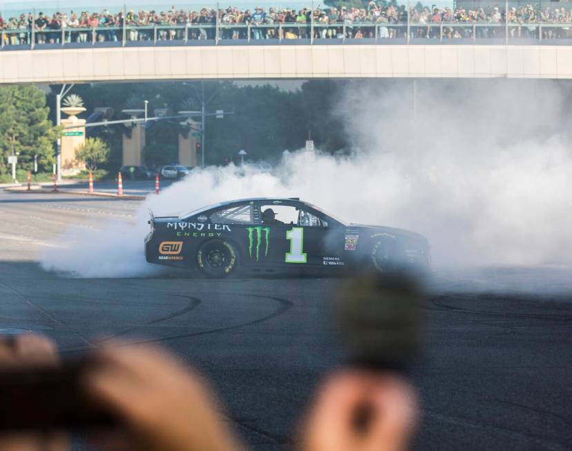 Kurt Busch does a burnout at the intersection of East Sands Avenue and South Las Vegas Boulevar ...