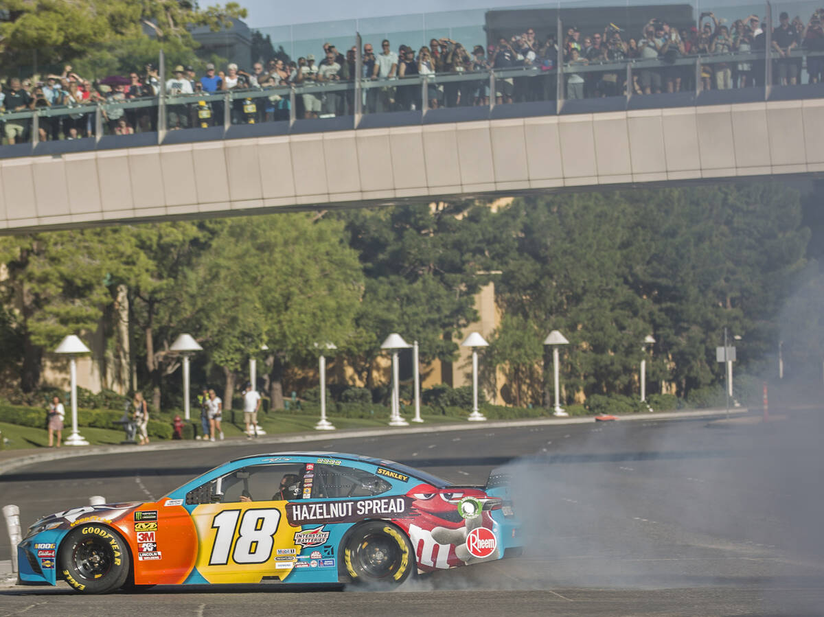 Kyle Busch does a burnout at the intersection of East Sands Avenue and South Las Vegas Boulevar ...