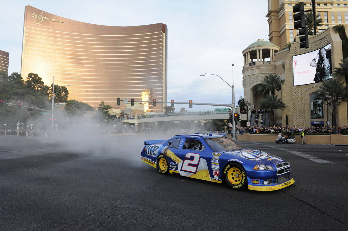2012 NASCAR Sprint Cup Series champion Brad Keselowski does a burnout on the Strip in front of ...