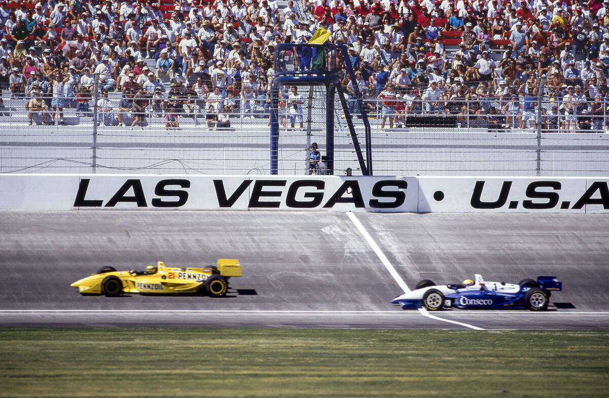 Roberto Guerrero, left, and Scott Sharp pass the start-finish line at the Las Vegas 500K IndyCa ...