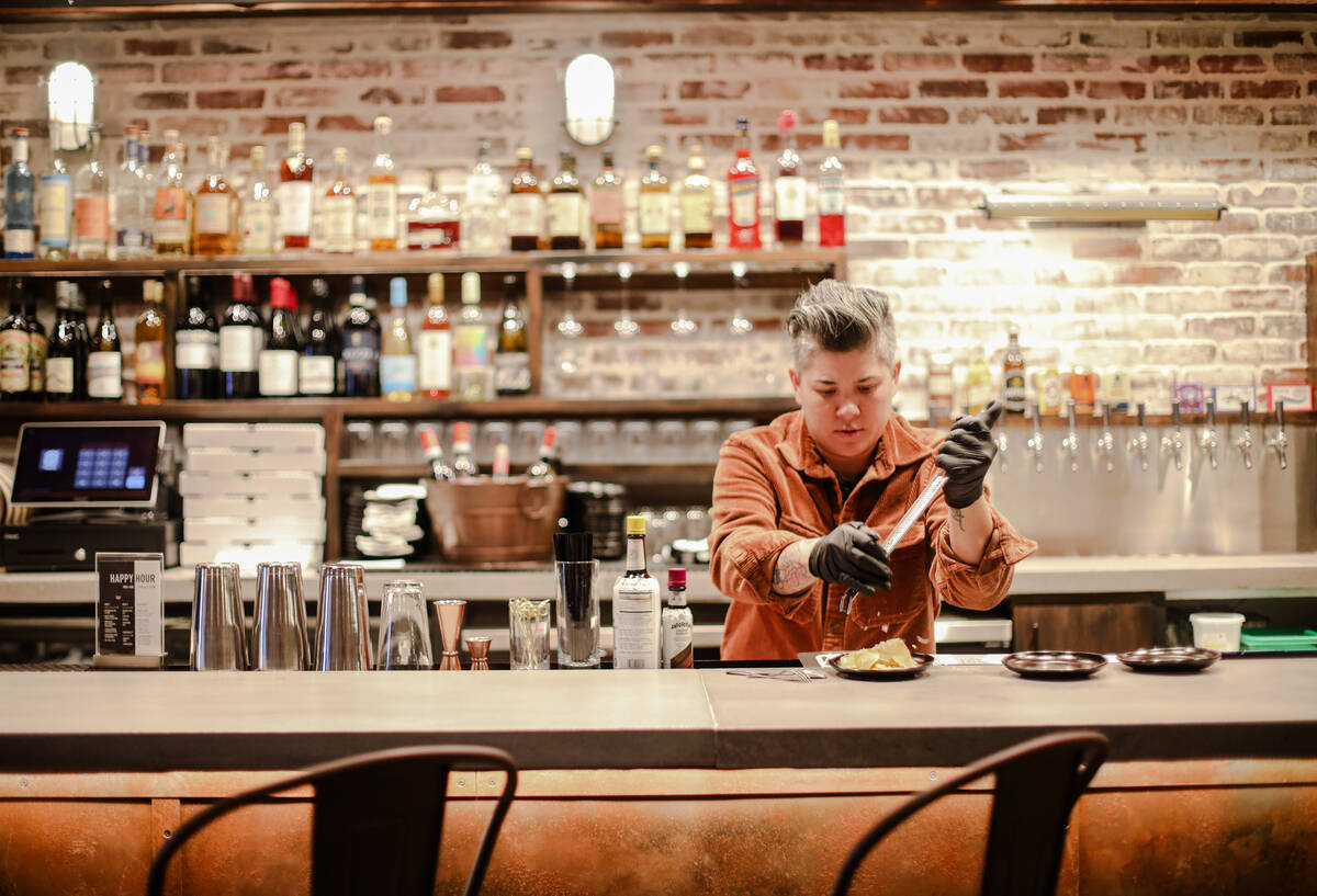 General manager Erica Bell prepares bar snacks at ØØ Pie & Pub, a pizza restaurant by world c ...