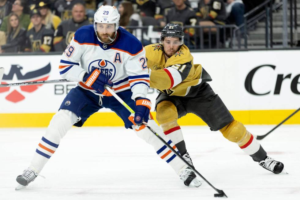 Golden Knights center Brett Howden (21) skates for the puck against Edmonton Oilers center Leon ...