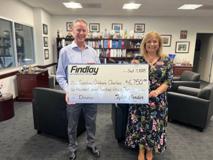 Tyler Corder, Findlay Automotive’s chief financial officer, presents a check to Paulette Ande ...