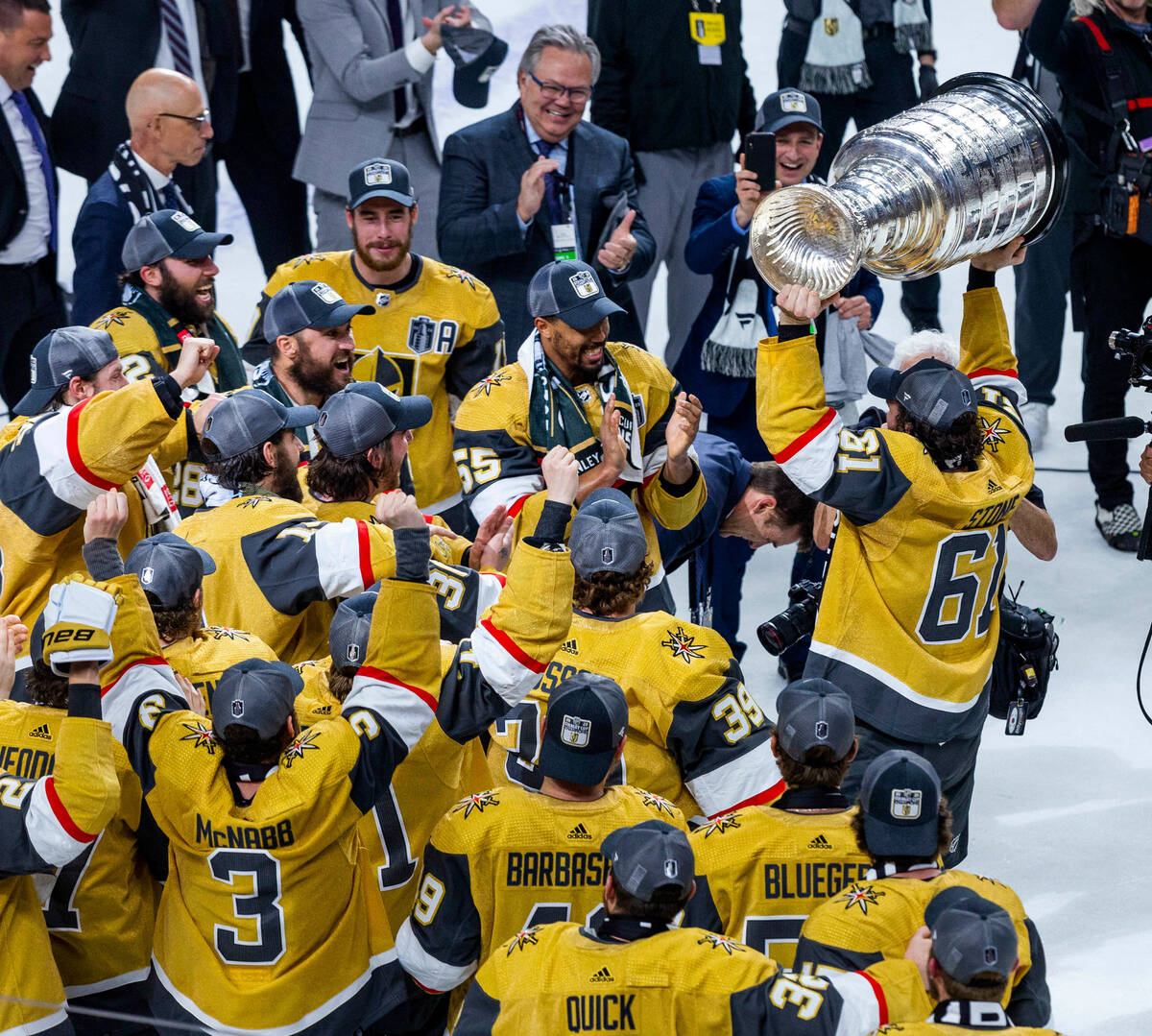 Golden Knights right wing Mark Stone (61) hoists the Stanley Cup before teammates defeating the ...