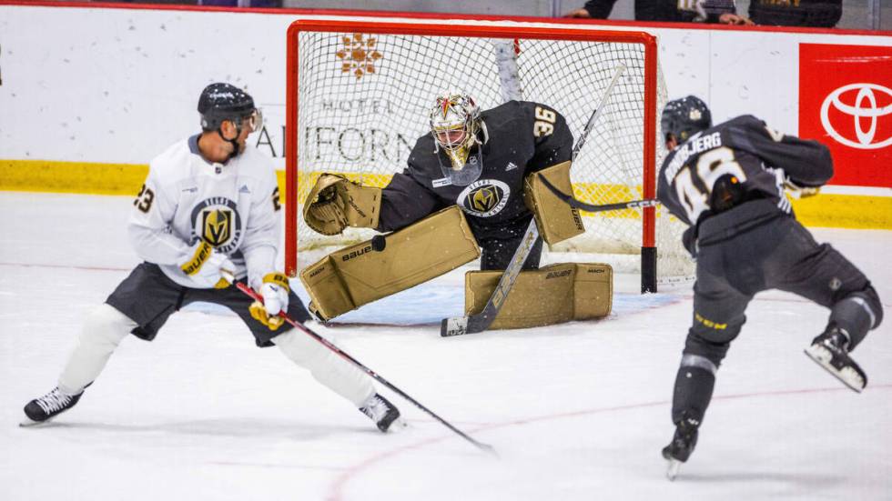 Golden Knights goalie Logan Thompson (36) blocks a shot by right wing Jonas Rondbjerg (46) duri ...