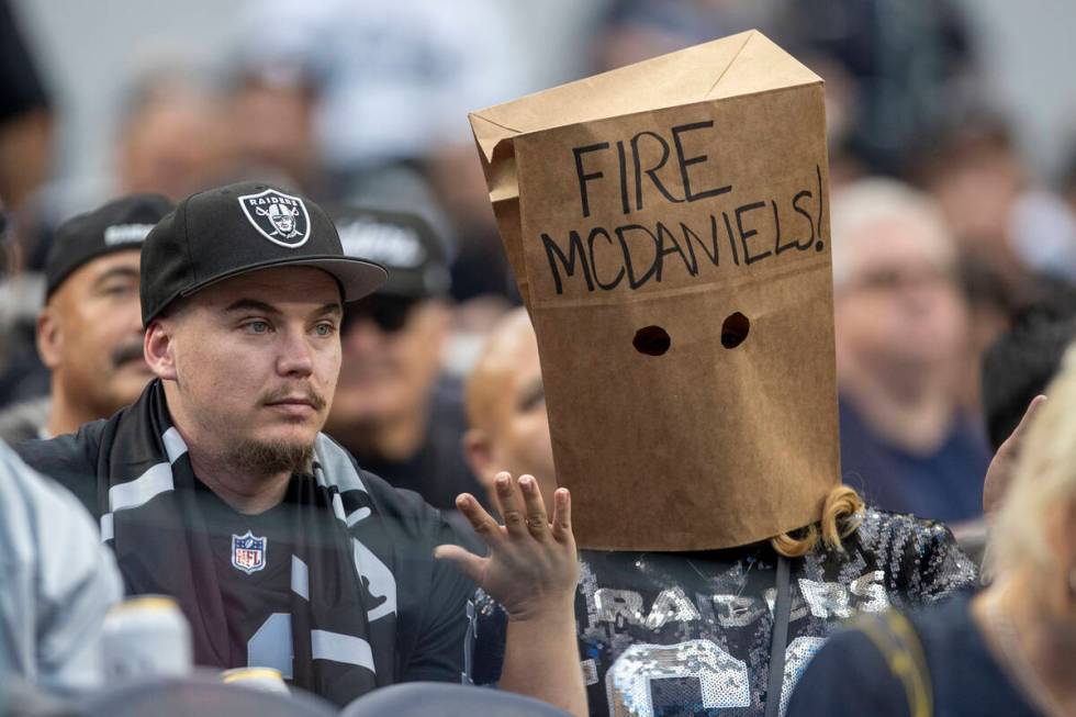 A Raiders fan wears a bag over her head with “Fire McDaniels” written on it durin ...