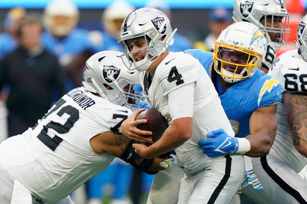 Las Vegas Raiders quarterback Aidan O'Connell (4) is sacked by Los Angeles Chargers linebacker ...