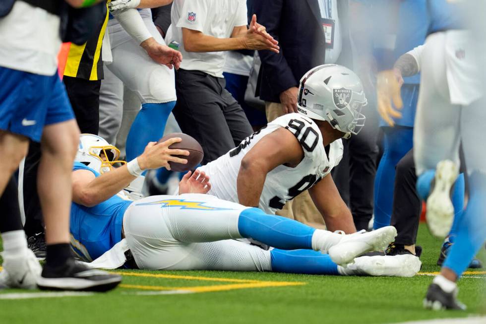 Las Vegas Raiders defensive tackle Jerry Tillery, right, hits Los Angeles Chargers quarterback ...