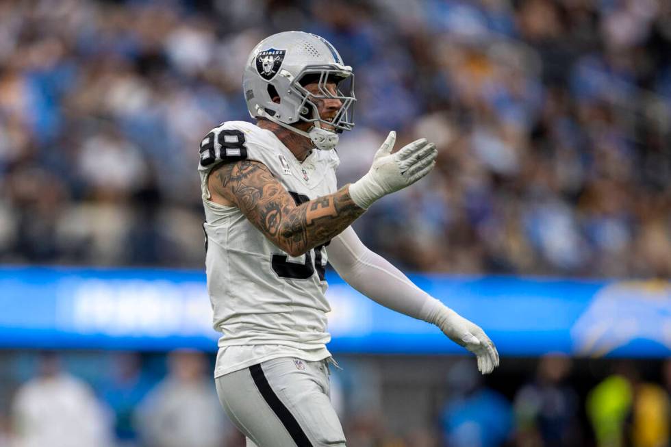 Raiders defensive end Maxx Crosby (98) celebrates his sack of Los Angeles Chargers quarterback ...