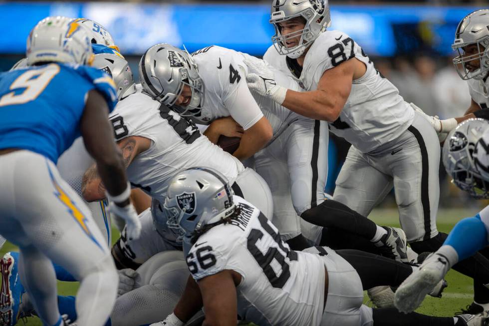 Raiders tight end Michael Mayer (87) helps push quarterback Aidan O'Connell (4) into the end zo ...