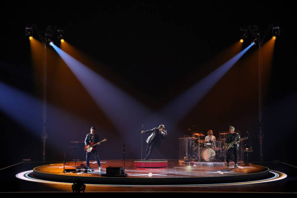 Bono, The Edge, Adam Clayton and Bram van den Berg of U2 perform during opening night of U2:UV ...