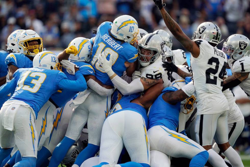 Los Angeles Chargers quarterback Justin Herbert (10) is stopped on fourth and one by Las Vegas ...