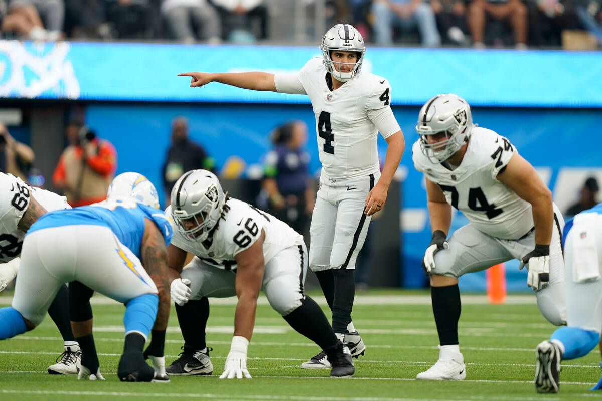 Las Vegas Raiders quarterback Aidan O'Connell (4) signals during the first half of an NFL footb ...