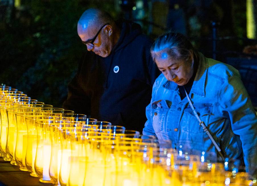 People stand around lit candles after Mayor Carolyn Goodman and David Riggleman, Las Vegas comm ...