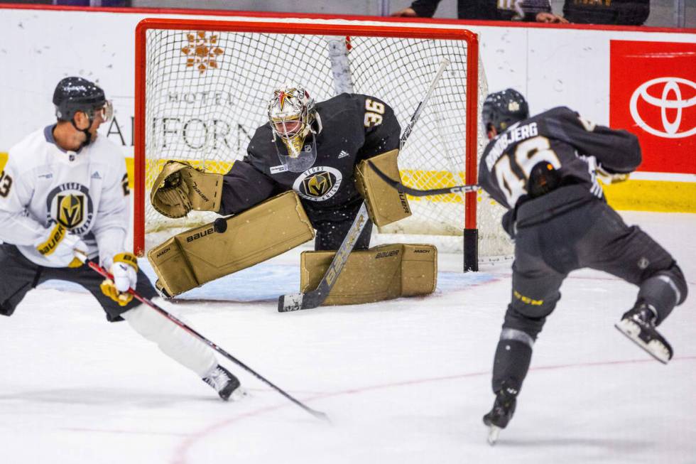 Golden Knights goalie Logan Thompson (36) blocks a shot by right wing Jonas Rondbjerg (46) duri ...