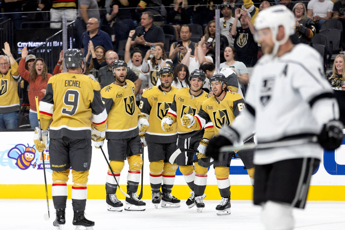 The Golden Knights celebrate a goal shot by center Brendan Brisson (19), third from right, duri ...