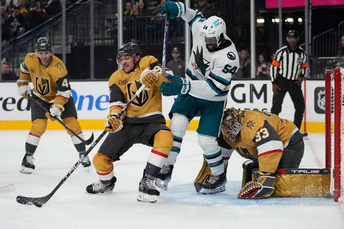 San Jose Sharks center Jacob Peterson (24) knocks the puck around Vegas Golden Knights left win ...