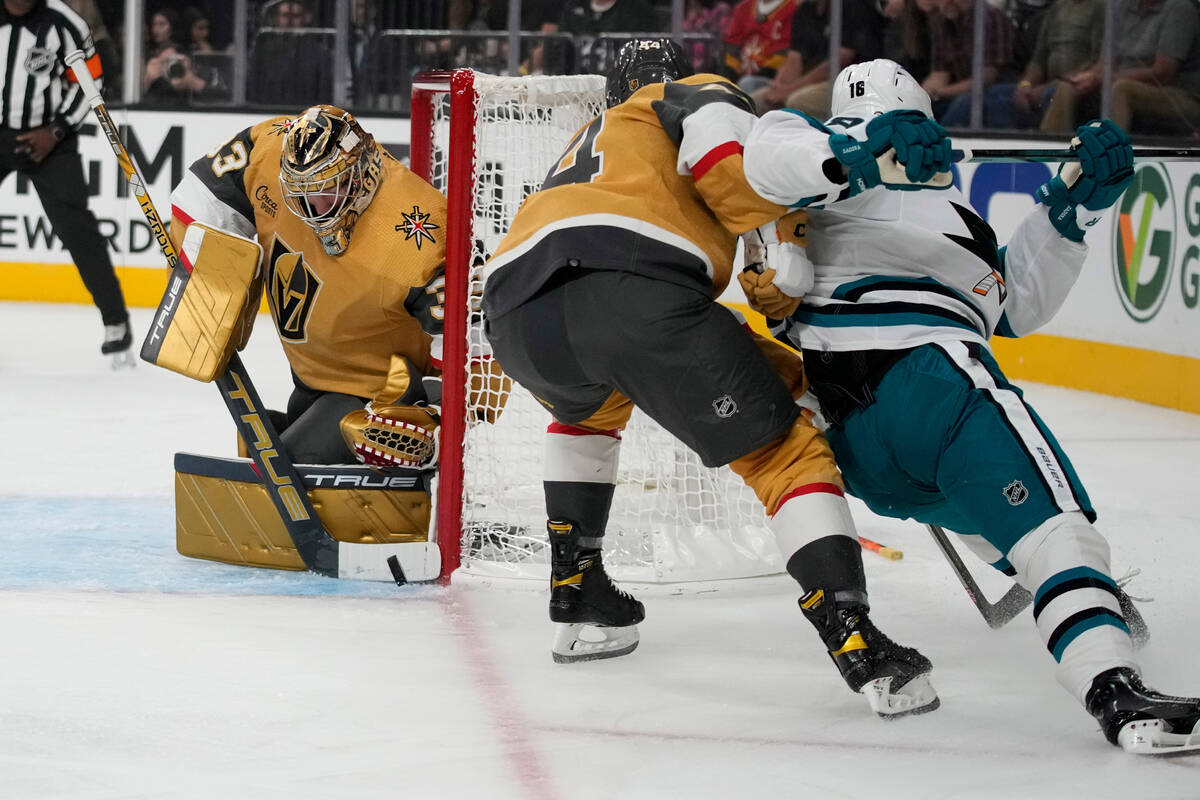 Vegas Golden Knights goaltender Adin Hill (33) stops a shot attempt by San Jose Sharks' Filip Z ...