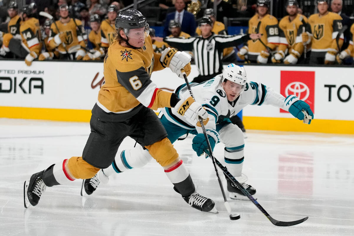 Vegas Golden Knights defenseman Kaedan Korczak (6) shoots around San Jose Sharks defenseman Jac ...