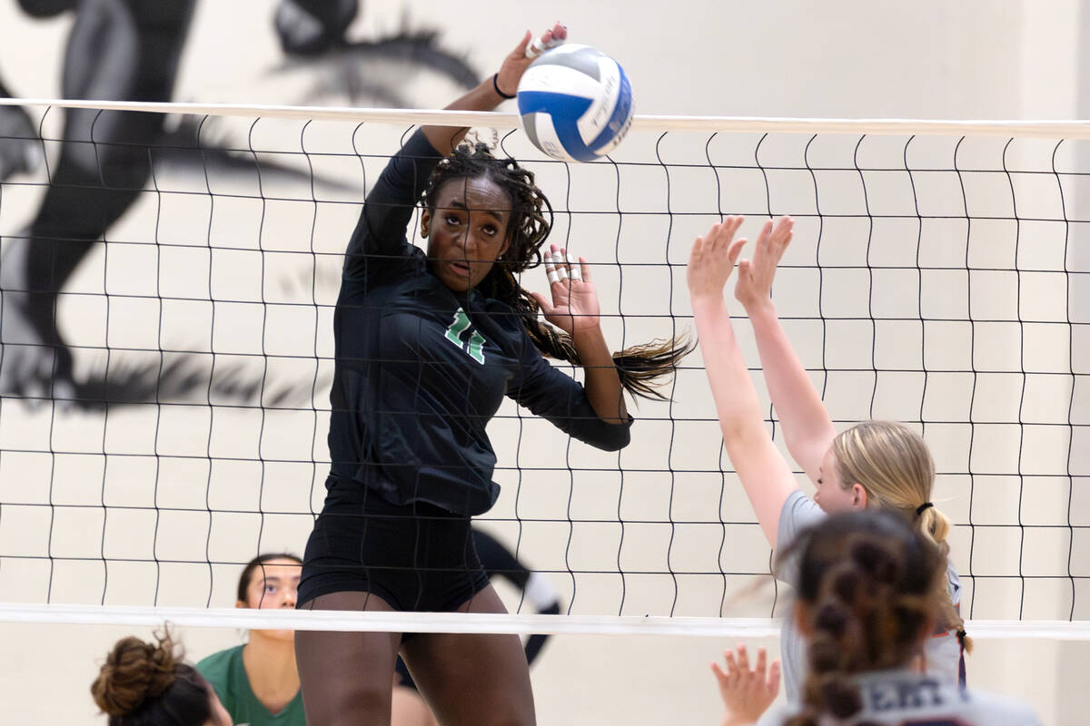 Palo Verde’s Deloris Nangah (11) spikes to Liberty during a high school volleyball game ...