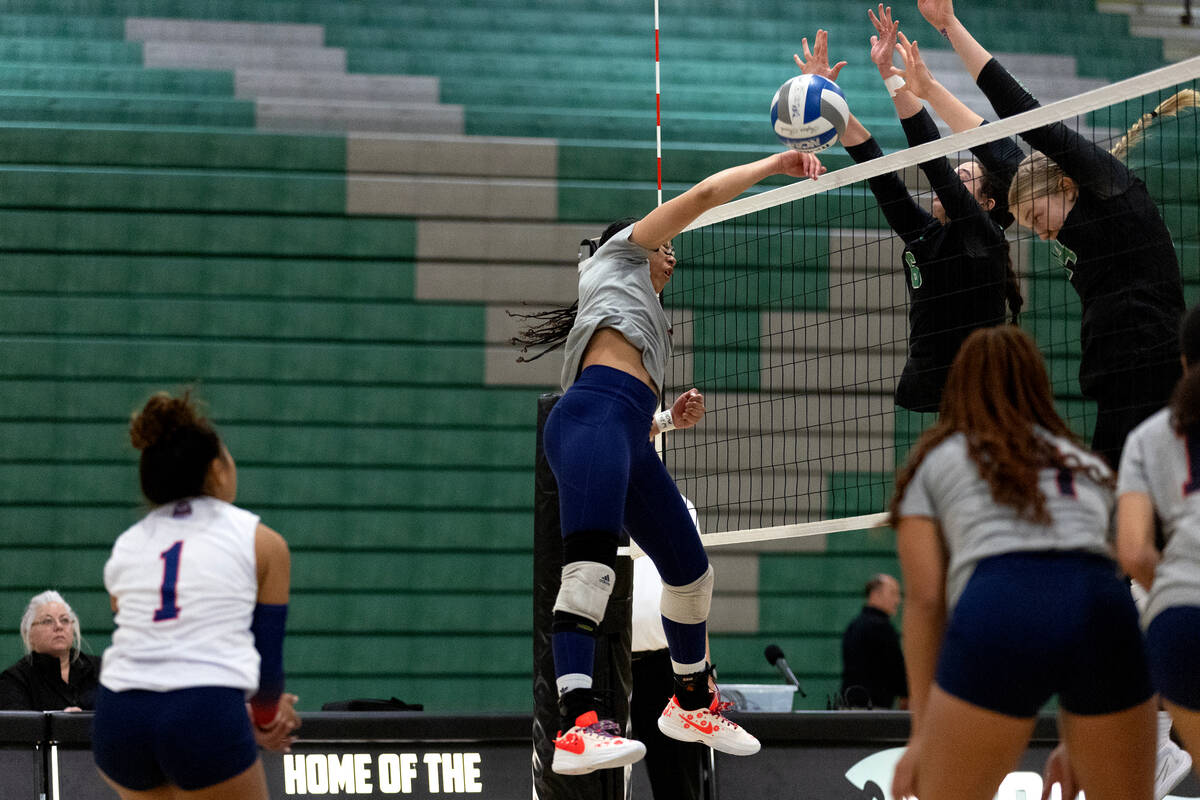 Liberty’s Jayda Hutchins spikes to Palo Verde’s Emma Neville (6) and Kate Camp du ...